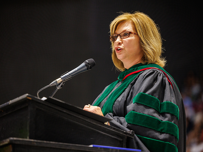 Dr. LouAnn Woodward, vice chancellor for health affairs and dean of the School of Medicine, urges the graduates to "remember the excitement, the spirit and the passion you have today and keep it with you."